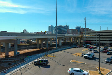 a aerial shot of a freeway with cars and semi trucks driving on the highway with construction...