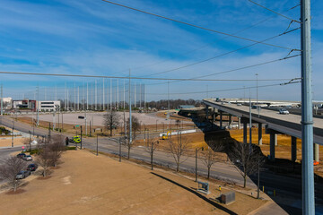 a shot of a freeway filled with cars and Semi trucks and tall power line poles along the highway...