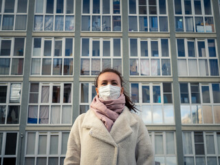 Shot of a girl in a mask, on the street. lockdown Covid-19 pandemic.