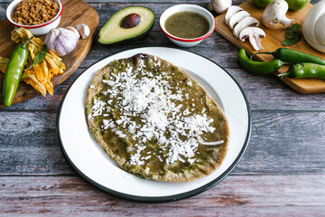 Memela sope quesadilla poblana of green sauce with cheese, onion and avocado traditional mexican food from Puebla, Mexico