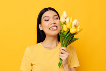 pretty brunette in a yellow t-shirt t-shirt with a bouquet of flowers holiday Monochrome shot