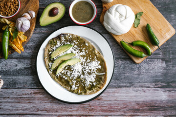 Memela sope quesadilla poblana of green sauce with cheese, onion and avocado traditional mexican food from Puebla, Mexico