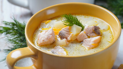Creamy fish soup with salmon, potatoes, onions , carrots, dill and celery . Kalakeitto- traditional dish of the Finnish cuisine or Russian  Ukha Fish Head Soup. Healthy Food Concept. Omega -3