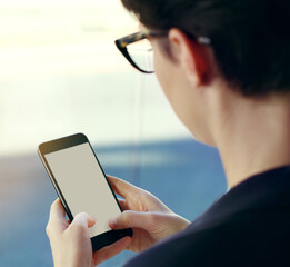 You can always reach her. Cropped shot of an unrecognizable young businesswoman using a mobile phone while standing on her office balcony.