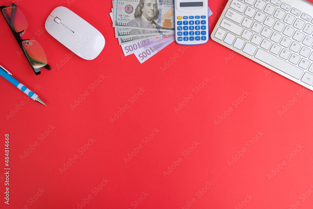 Poster blank notebook with a pen sits on an office desk table surrounded by computer tools and a range of m