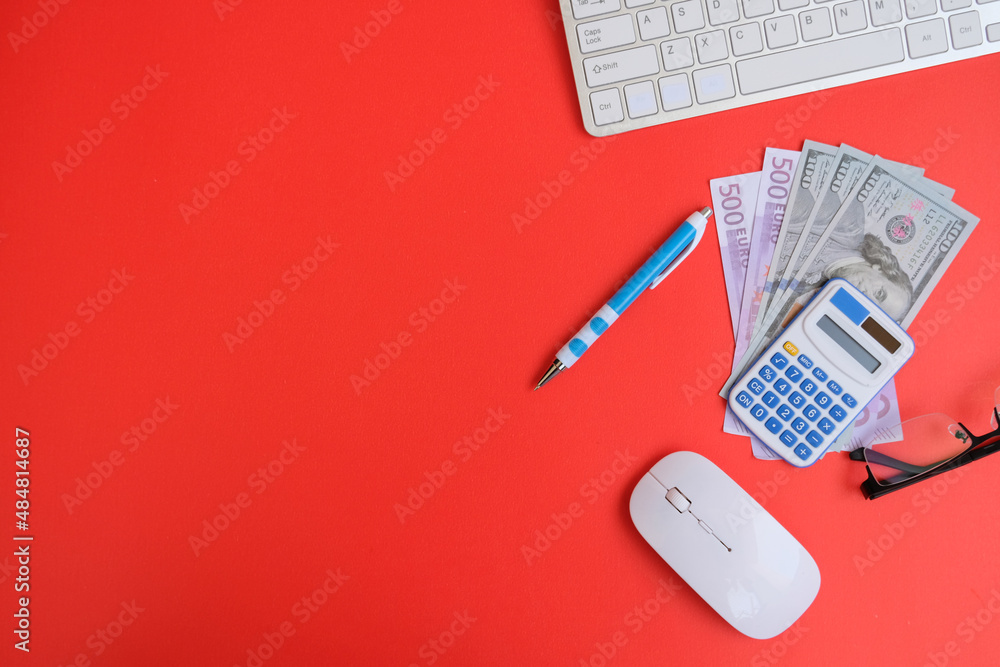 Poster blank notebook with a pen sits on an office desk table surrounded by computer tools and a range of m