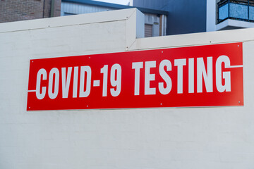 COVID-19 testing clinic sign on a wall. Coronavirus PCR test