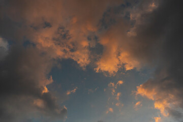 White clouds floating on blue sky during sunset.