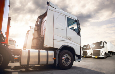 Semi Trailer Trucks on the Parking lot at The Sunset Sky. Delivery Trucks. Cargo Shipping. Lorry....