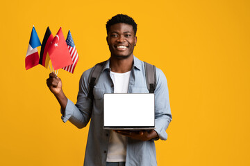 Happy black guy with flags and laptop, mockup