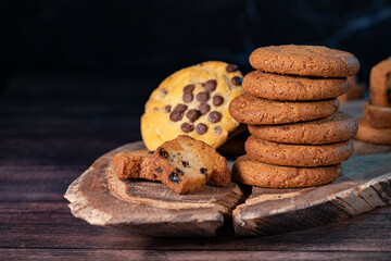 Homemade cookies with chocolate, nuts and coffee beans on a  wooden background  with a background blur.