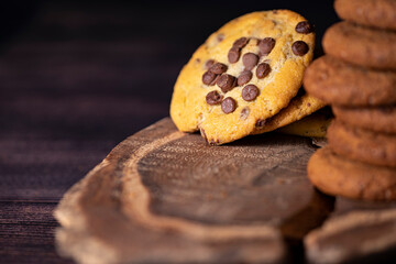 Homemade cookies with chocolate, nuts and coffee beans on a  wooden background  with a background blur.