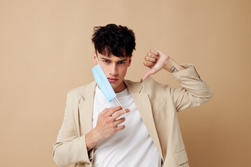 A young man in a medical mask in the hands of posing fashion isolated background unaltered