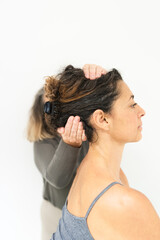 Naklejka premium Yoga and alternative therapies teacher, positioning a student in the head position.