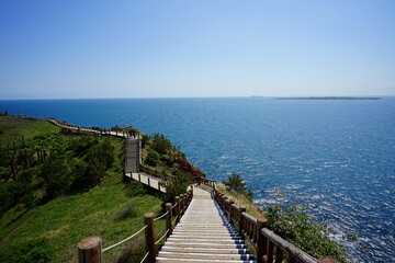 Obraz premium seaside cliff walkway and distant island