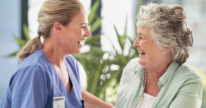 Laughter is the best medicine. Caring nurse showing support to a happy old lady patient at home or hospital. Smiling female doctor hugging a mature senior woman with an elderly healthcare concept