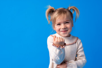 Naughty little girl over the blue background