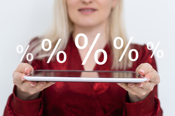 A human hand with a tablet showing sale percent discount