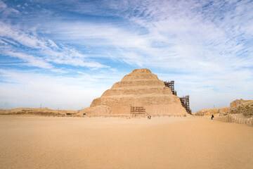 The Pyramids in Egypt under cloudy sky.