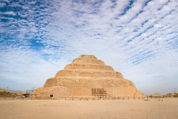 The Pyramids in Egypt under cloudy sky.