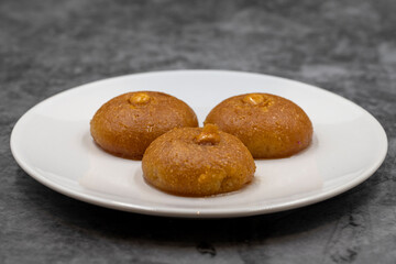 Traditional Turkish dessert sekerpare on a dark background. Turkish dessert with syrup, ramadan and feast treat. Close up