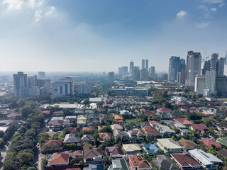 Naklejka premium Aerial shot of the Manila skyline skyscraper clusters as seen from Corinthian Gardens. 