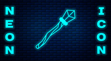 Glowing neon Magic staff icon isolated on brick wall background. Magic wand, scepter, stick, rod. Vector