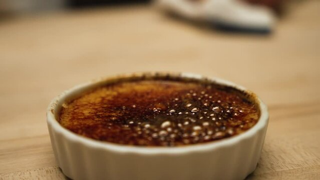 Molten sugar bubbling and boiling on creme brulee slow motion 4k 30p