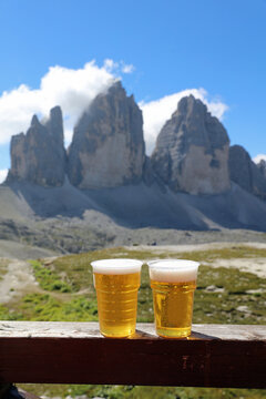 Cups of Beer with the three Peaks of Lavaredo. Dolomites. South Tyrol. Italy