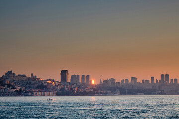 Houses on the sea coast at dawn. View of the city from the sea, boats, skyscrapers at sunrise. Journey to istanbul