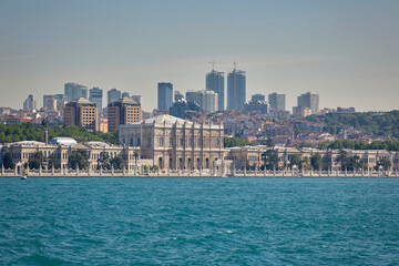 View of the Dolmabahce Palace from the sea, a city on the seashore, skyscrapers, sights of Istanbul
