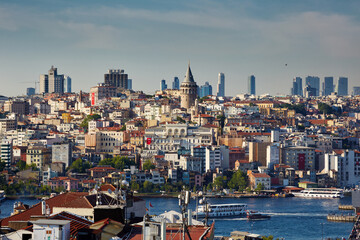 Beautiful view of the historical district of Istanbul, the Galata Bridge and the Galata Tower, the Golden Horn Bay. Sailing tourist boats. Travel to Istanbul, Turkey.
