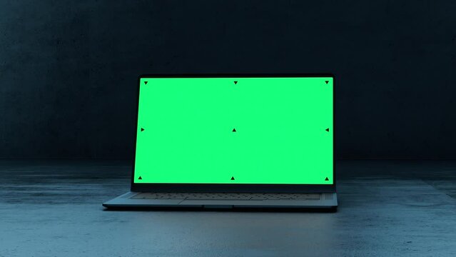 Mockup Shot of a Laptop Computer with Green Screen in Dark Concrete Environemnt