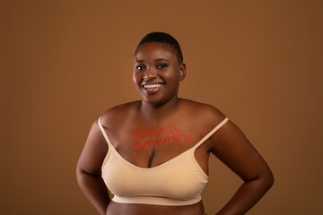 Curvy Smiling Black Woman Posing With Inscription On Her Chest