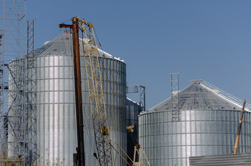 Construction site. Installation of cylindrical silos for grain s