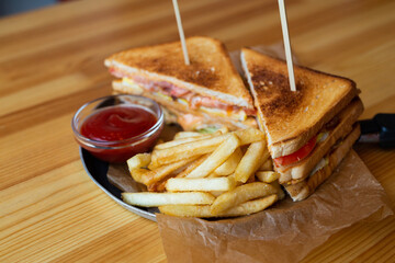 delicious sandwiches with sauce and french fries 