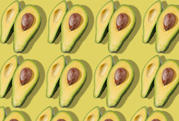 Sliced avocado a lot. Avocado pattern on a bright background. Hard light.