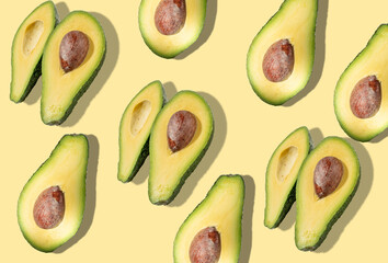 Pattern of many avocados with hard light. Flat lay, top view.