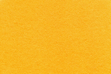 Texture of bright yellow and orange colors paper background, macro. Structure of dense golden...