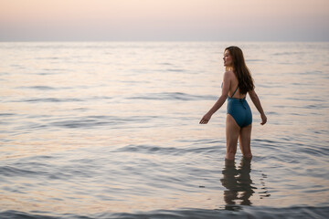 Fototapeta na wymiar happy woman in swimsuit on sea beach at Koh Chang island, Thailand