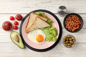 Concept of tasty breakfast on white wooden background