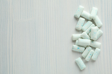 Chewing or bubble gum on white wooden background