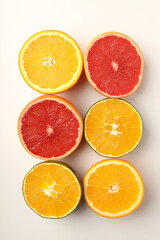 Citrus fruits halves on white background, top view