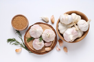 Garlic and mustard seeds on white background