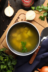 Concept of tasty food with chicken soup or broth on wooden background