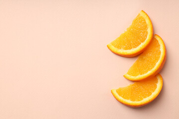 Orange slices on beige background, space for text