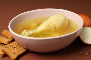 Concept of tasty food with chicken soup on brown background