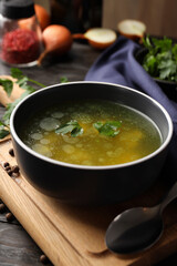 Concept of tasty food with chicken soup or broth on wooden table