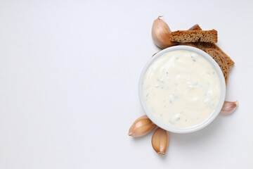 Fototapeta na wymiar Garlic sauce, ingredients and snacks on white background