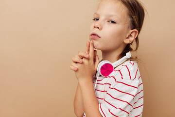 pretty young girl in striped t-shirt headphones gesture hands childhood unaltered